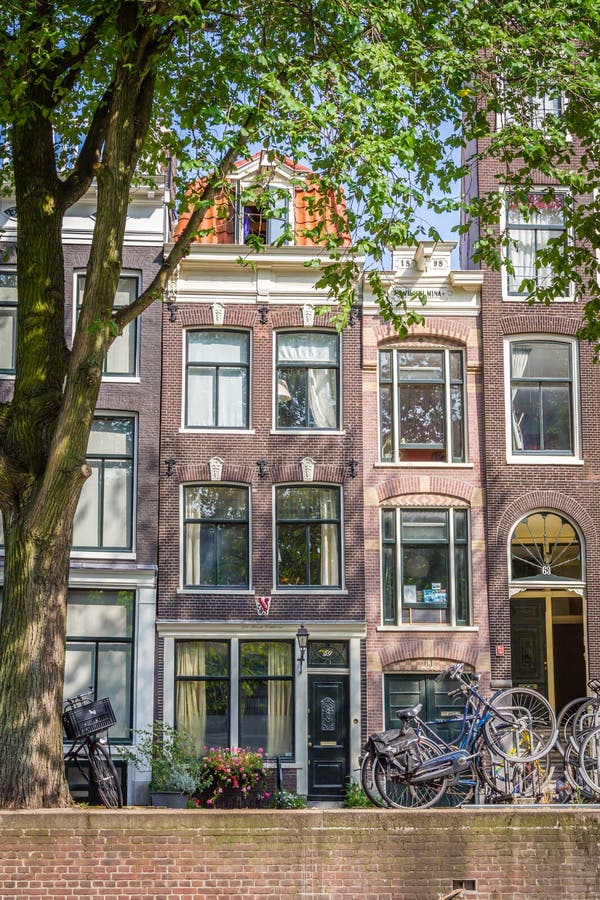 A typical very narrow house in old Amsterdam stock image A typical very narrow house in old Amsterdam stock image