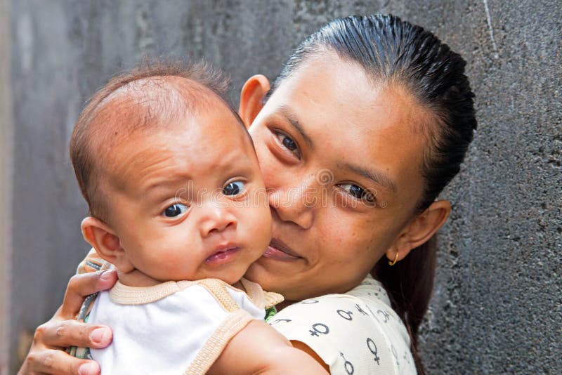 Typically indonesian mother with her little baby in Lombok, Indonesia stock photo Typically indonesian mother with her little baby in Lombok, Indonesia stock photo