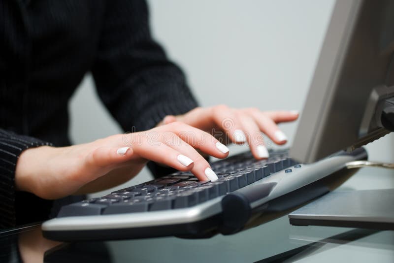 Woman typing on computer keyboard