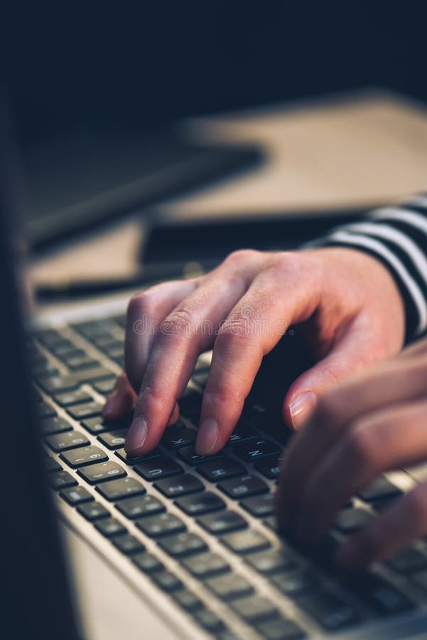 Typing hands and laptop computer in office royalty free stock photo