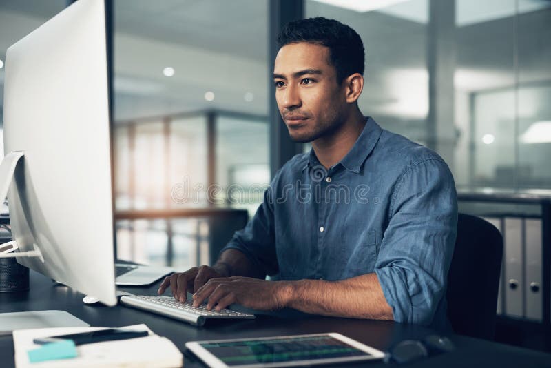 Typing, man and programmer on computer in office at night for deadline. IT, focus and male coder, engineer or person stock photography