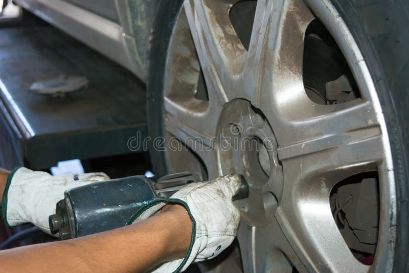 Tyre Repairer Fixing a Wheel Using an Impact Wrench Stock Photo Image