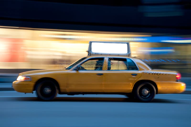 Taxi on an urban street at night, blurred as it races down the street. Use the empty copyspace on top to place your message. Taxi on an urban street at night, blurred as it races down the street. Use the empty copyspace on top to place your message.