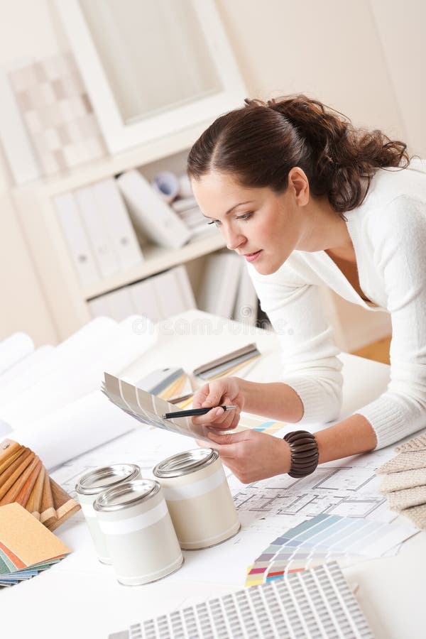 Tânără femeie designer interior cu vopsea stock photo