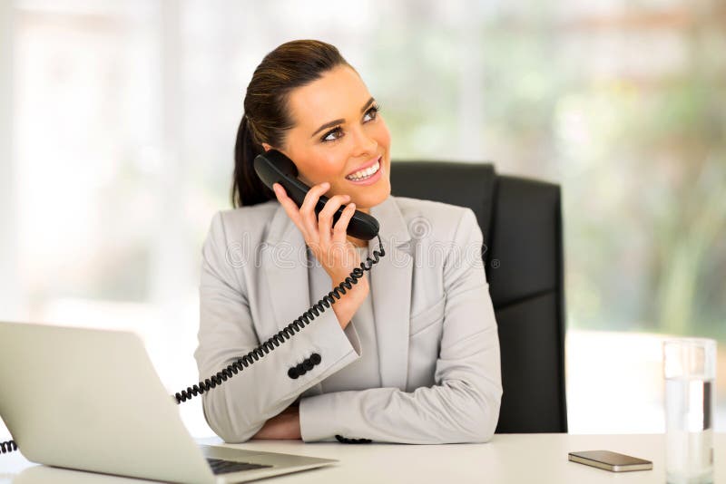 Gorgeous office worker talking on telephone. Gorgeous office worker talking on telephone