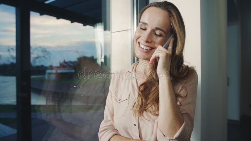 Téléphone parlant de femme d'affaires dans la maison de luxe Téléphone portable parlant de femme décontractée