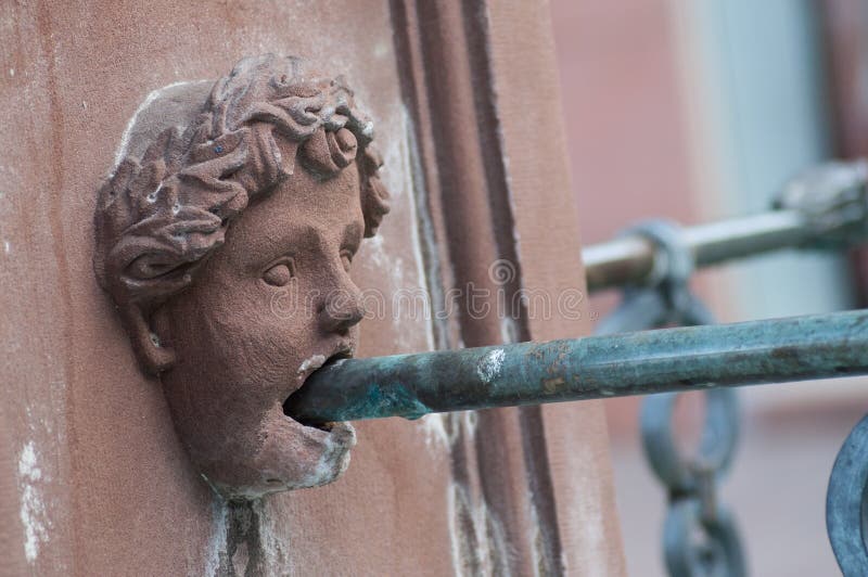 Closeup of stoned head in fountain in Mulhouse - France. Closeup of stoned head in fountain in Mulhouse - France