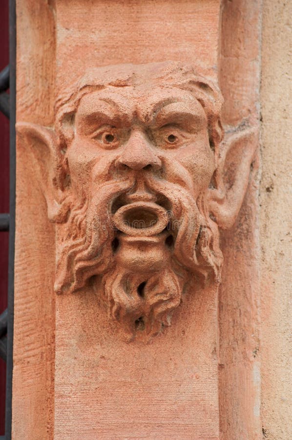 Closeup of stoned head on building facade. Closeup of stoned head on building facade