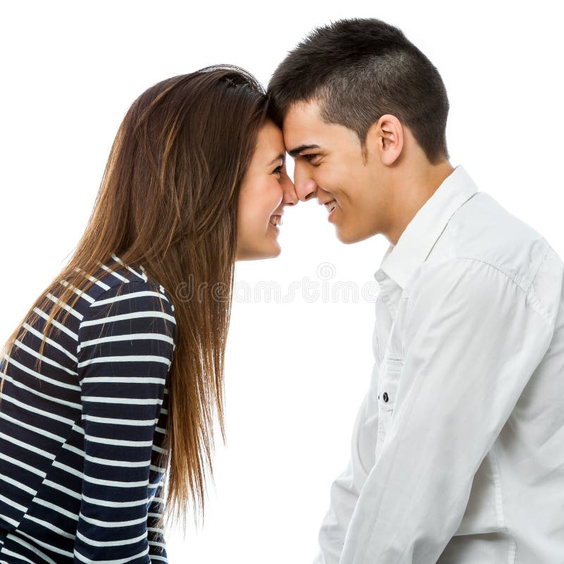 Close up portrait of teen couple joining heads. on white background. Close up portrait of teen couple joining heads. on white background.