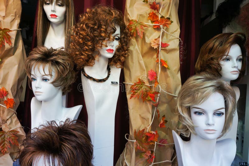 Female wigs or toupees on manikin heads. Female wigs or toupees on manikin heads.