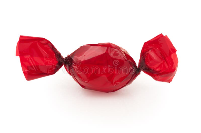 Either a piece of hard candy or a cough drop wrapped in bright red cellophane and on a white background. Closeup shot. Either a piece of hard candy or a cough drop wrapped in bright red cellophane and on a white background. Closeup shot.