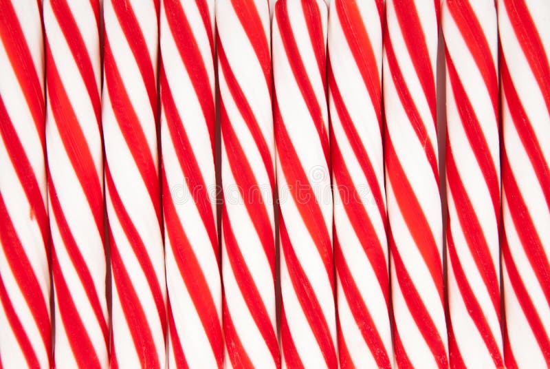 A background made of red and white striped candy canes. A background made of red and white striped candy canes