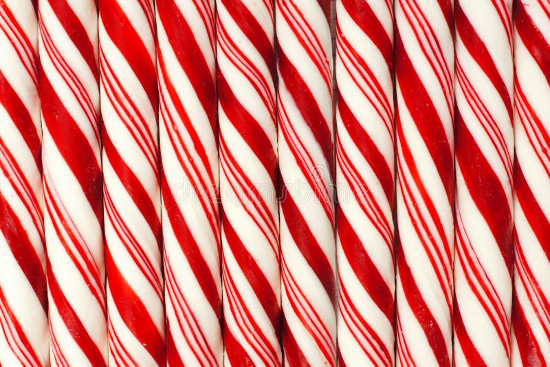 Full background of red and white striped Christmas candy canes. Full background of red and white striped Christmas candy canes