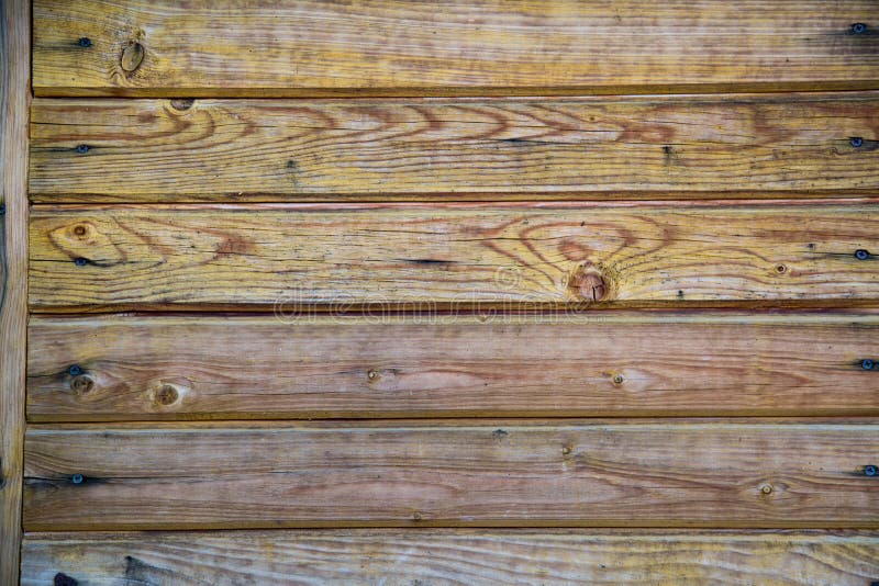 Background of old boards yellow and purple with knots hammered nails. Design backgrounds texture. Background of old boards yellow and purple with knots hammered nails. Design backgrounds texture.