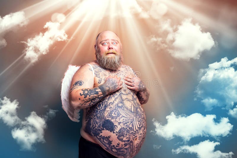 Amazed man with beard ,tattoos and wings acts like an angel. Amazed man with beard ,tattoos and wings acts like an angel