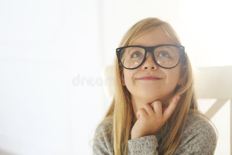 U?miechni?ta ?liczna ma?a dziewczynka z czarnymi eyeglasses nad bia?ym t?em obrazy stock U?miechni?ta ?liczna ma?a dziewczynka z czarnymi eyeglasses nad bia?ym t?em obrazy stock