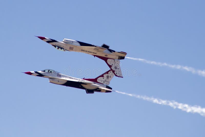 The United States Air Force Thunderbirds Air Demonstration Squadron performs for spectators at Luke Air Force Base in Glendale, Arizona, USA. These highly trained United State Air Force pilots fly in very close high precision aerobatic formations in air shows throughout the United States and around the world. The name Thunderbird is derived from a legendary creature from myths of indigenous North American cultures. The Thunderbirds fly specially marked F-16's. The F-16 (Fighting Falcon) is a very prominent and successful jet fighter aircraft developed by General Dynamics and Lockheed Martin of the United States. Designed as a lightweight fighter, it has evolved to being a highly successful multirole aircraft. In addition to air demonstrations, the USAF Thunderbirds are part of the Air Force combat forces and a component of the 57th Wing. If needed, the team's personnel and aircraft can be rapidly integrated into a fighter unit at their home base Nellis Air Force Base, Nevada. The United States Air Force Thunderbirds Air Demonstration Squadron performs for spectators at Luke Air Force Base in Glendale, Arizona, USA. These highly trained United State Air Force pilots fly in very close high precision aerobatic formations in air shows throughout the United States and around the world. The name Thunderbird is derived from a legendary creature from myths of indigenous North American cultures. The Thunderbirds fly specially marked F-16's. The F-16 (Fighting Falcon) is a very prominent and successful jet fighter aircraft developed by General Dynamics and Lockheed Martin of the United States. Designed as a lightweight fighter, it has evolved to being a highly successful multirole aircraft. In addition to air demonstrations, the USAF Thunderbirds are part of the Air Force combat forces and a component of the 57th Wing. If needed, the team's personnel and aircraft can be rapidly integrated into a fighter unit at their home base Nellis Air Force Base, Nevada.