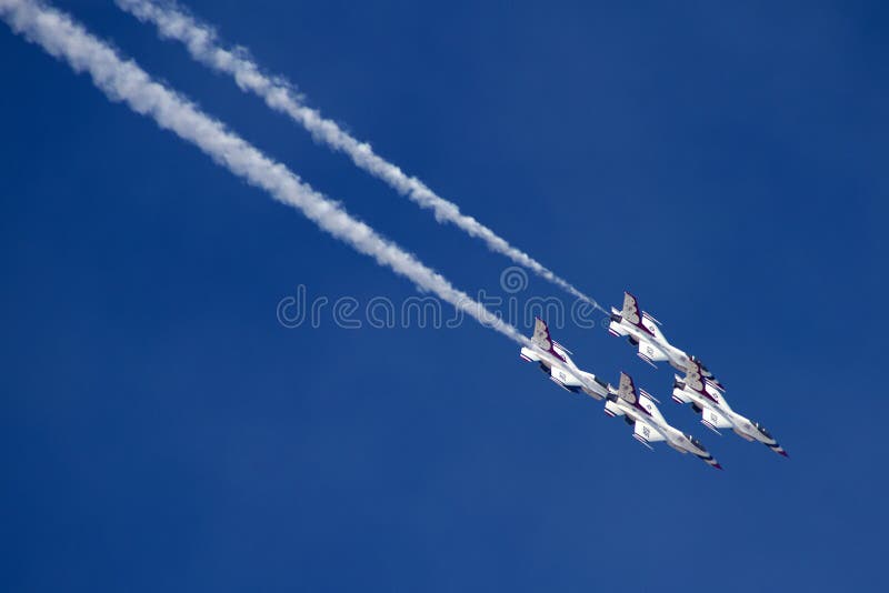 The United States Air Force Thunderbirds Air Demonstration Squadron performs for spectators at Luke Air Force Base in Glendale, Arizona, USA. These highly trained United State Air Force pilots fly in very close high precision aerobatic formations in air shows throughout the United States and around the world. The name Thunderbird is derived from a legendary creature from myths of indigenous North American cultures. The Thunderbirds fly specially marked F-16's. The F-16 (Fighting Falcon) is a very prominent and successful jet fighter aircraft developed by General Dynamics and Lockheed Martin of the United States. Designed as a lightweight fighter, it has evolved to being a highly successful multirole aircraft. In addition to air demonstrations, the USAF Thunderbirds are part of the Air Force combat forces and a component of the 57th Wing. If needed, the team's personnel and aircraft can be rapidly integrated into a fighter unit at their home base Nellis Air Force Base, Nevada. The United States Air Force Thunderbirds Air Demonstration Squadron performs for spectators at Luke Air Force Base in Glendale, Arizona, USA. These highly trained United State Air Force pilots fly in very close high precision aerobatic formations in air shows throughout the United States and around the world. The name Thunderbird is derived from a legendary creature from myths of indigenous North American cultures. The Thunderbirds fly specially marked F-16's. The F-16 (Fighting Falcon) is a very prominent and successful jet fighter aircraft developed by General Dynamics and Lockheed Martin of the United States. Designed as a lightweight fighter, it has evolved to being a highly successful multirole aircraft. In addition to air demonstrations, the USAF Thunderbirds are part of the Air Force combat forces and a component of the 57th Wing. If needed, the team's personnel and aircraft can be rapidly integrated into a fighter unit at their home base Nellis Air Force Base, Nevada.