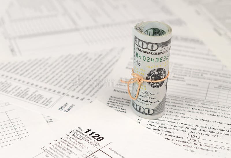 1120 U.S. Corporation income tax return form with roll of american dollar banknotes stock image 1120 U.S. Corporation income tax return form with roll of american dollar banknotes stock image
