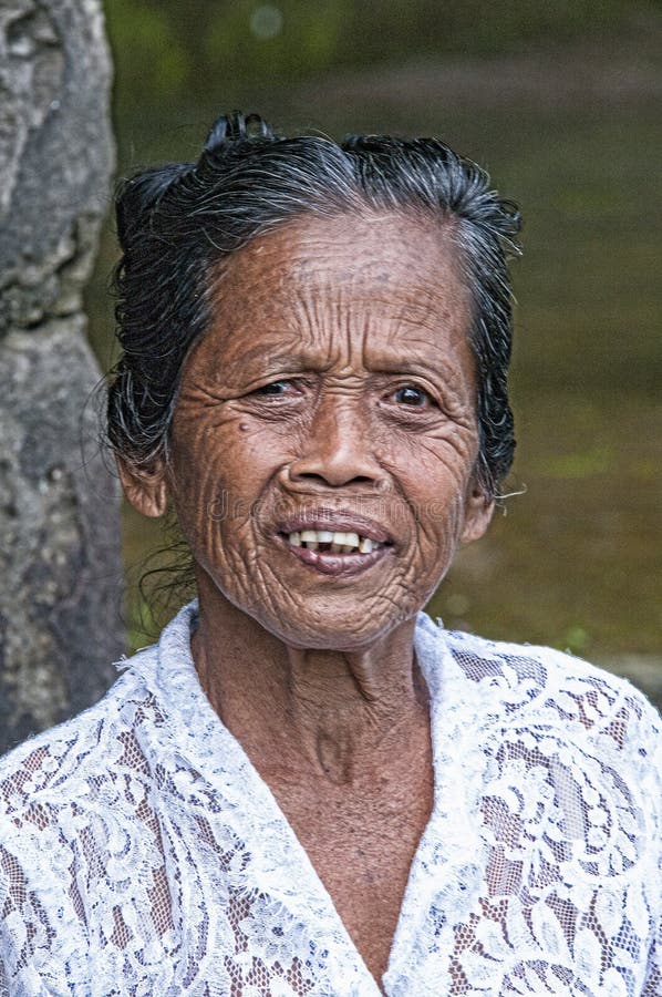 Ubud, Indonesia - July 28, 2013. An unidentified Balinese rice very old farmer poses during a morning`s work near Ubud