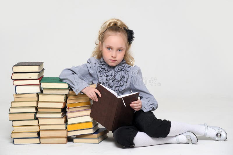 Young schoolgirl and a lot of books. Young schoolgirl and a lot of books