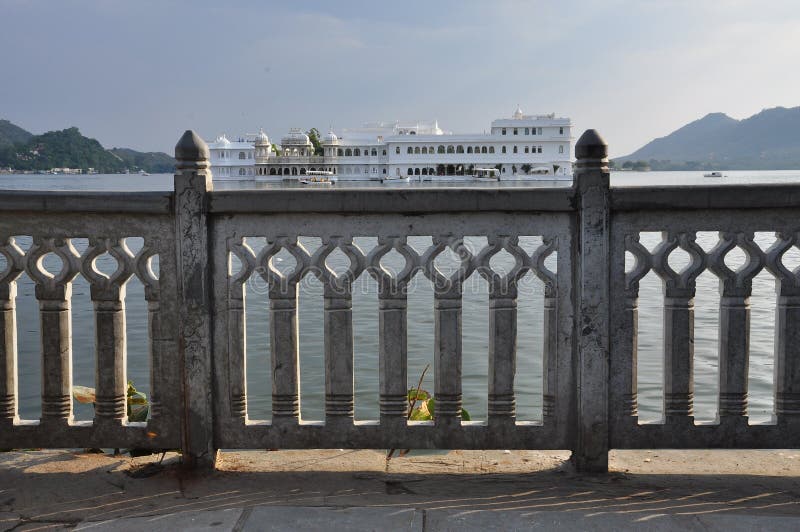 City of Udaipur, Rajasthan, India. Old Indian luxurious palace hotel on an island in Lake Pichola. Traditional architecture. City of Udaipur, Rajasthan, India. Old Indian luxurious palace hotel on an island in Lake Pichola. Traditional architecture