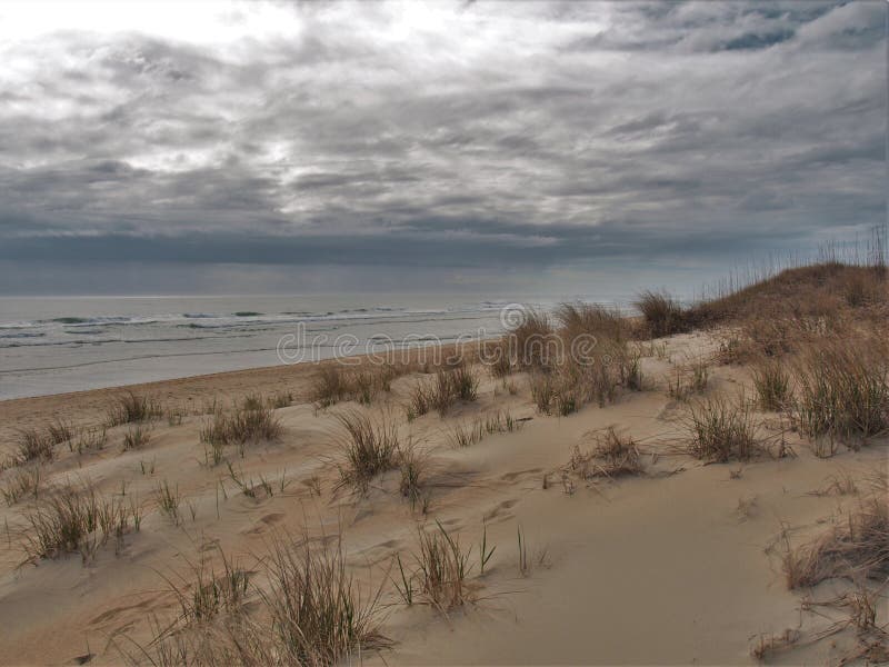 UddeHatteras dyn och hav under molniga himlar arkivbilder