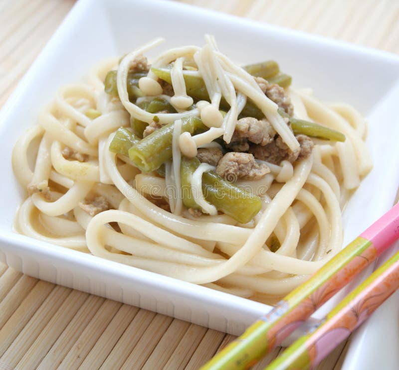 Udon Noodles with Meat, Mushrooms and Vegetables. Sprinkled with Sesame Seeds Stock Image