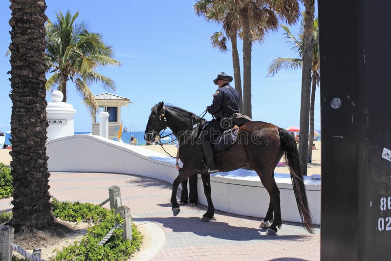 FORT LAUDERDALE, FLORIDA - APRIL 8, 2013: The Mounted Police Unit has been around locally since 1983, is very effective in crowd control, keeping the peace and may be seen more during spring break. FORT LAUDERDALE, FLORIDA - APRIL 8, 2013: The Mounted Police Unit has been around locally since 1983, is very effective in crowd control, keeping the peace and may be seen more during spring break.