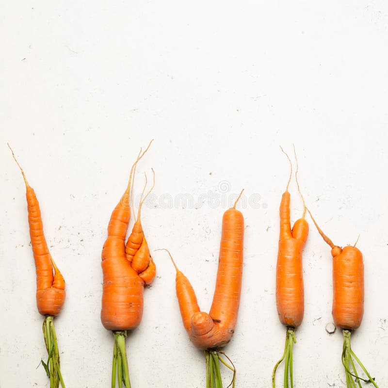 Ugly carrots on a white background. Ugly food concept, top view