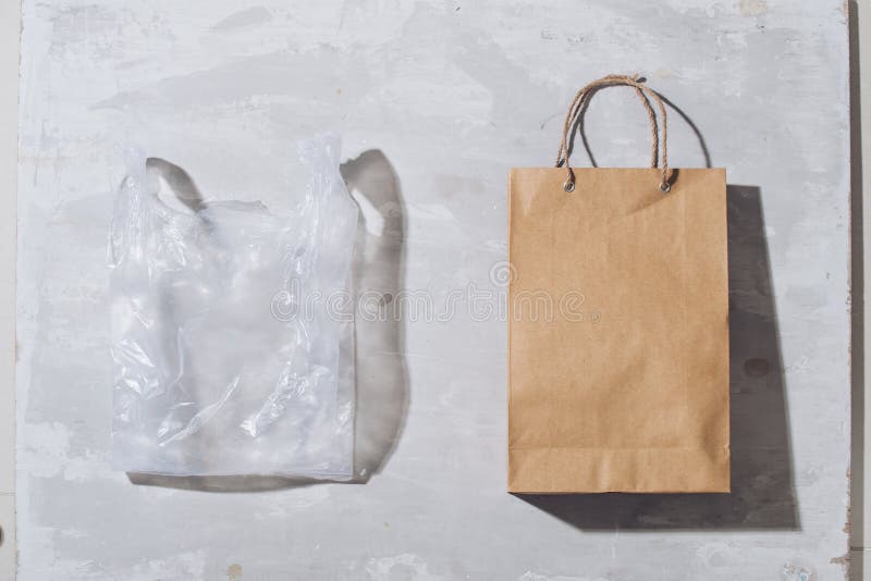 Ugly colorful plastic bag vs brown recyclable eco paper bag. Reduce, Reuse and Recycle concept. Flat lay, view from above, isolated on white.