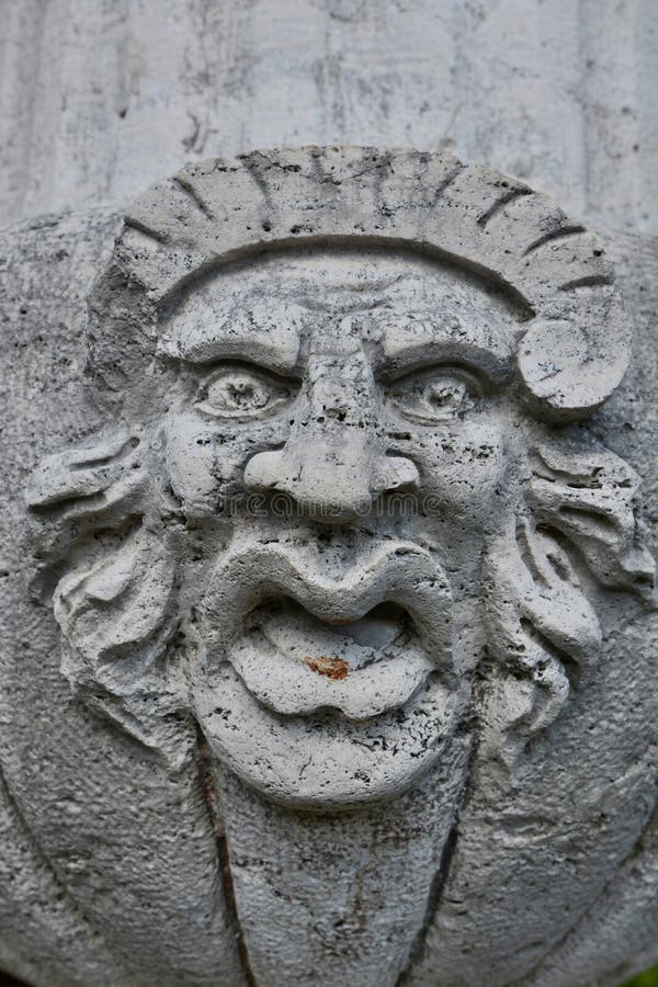 Ugly stone face sculpture stock photo. Image of face 56637264