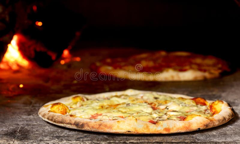 Delicious pizza baking in wood fired oven. Delicious pizza baking in wood fired oven