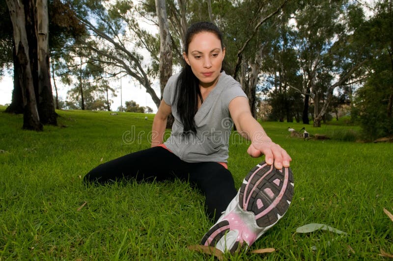 Young woman performing stretching exercises. Young woman performing stretching exercises.