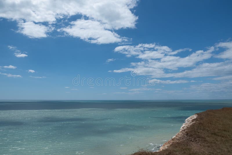 UK coastline blue sky and sea reflection with white cliffs. UK coastline with blue sky and sea reflection on summer day with white cliffs royalty free stock photos UK coastline blue sky and sea reflection with white cliffs. UK coastline with blue sky and sea reflection on summer day with white cliffs royalty free stock photos