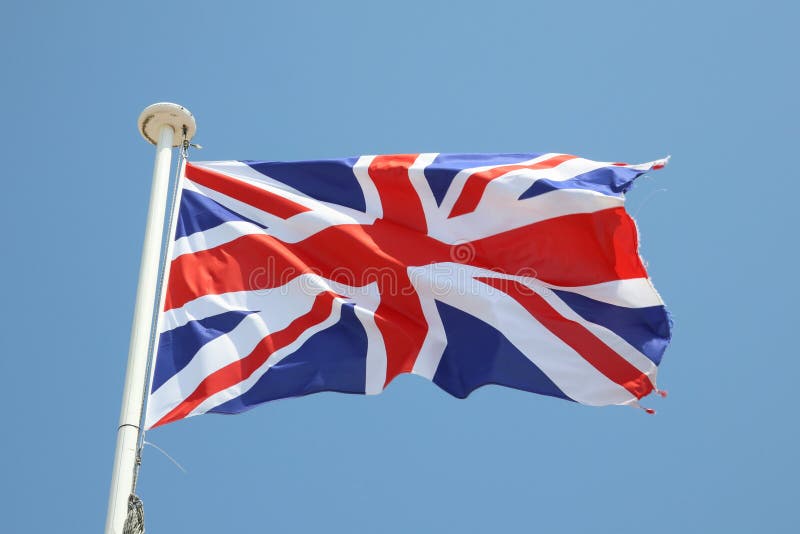 Uk flag on a mat in the wind and blue sky