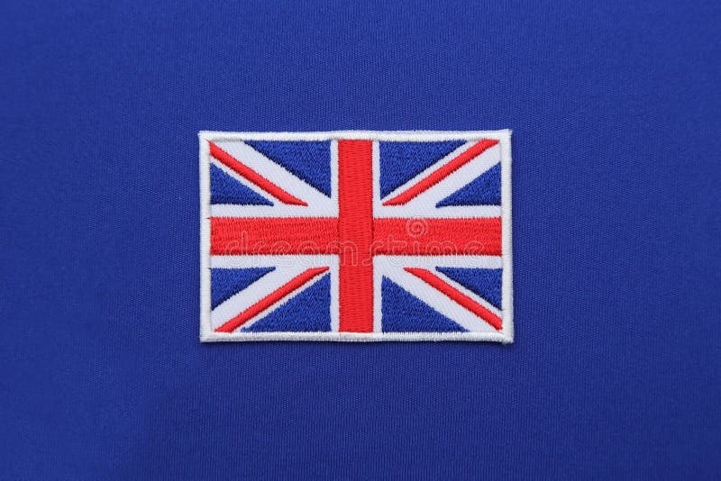 Uk flag patch on blue fabric. Uk flag patch on blue fabric