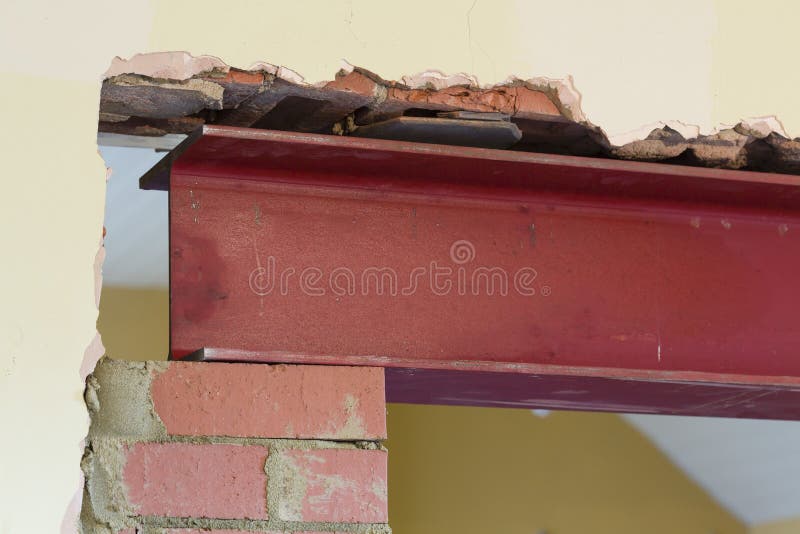 UK house building work with steel RSJ beam. New wall opening supported by RSJ universal steel beam, part of building work in a UK house renovation stock photography UK house building work with steel RSJ beam. New wall opening supported by RSJ universal steel beam, part of building work in a UK house renovation stock photography