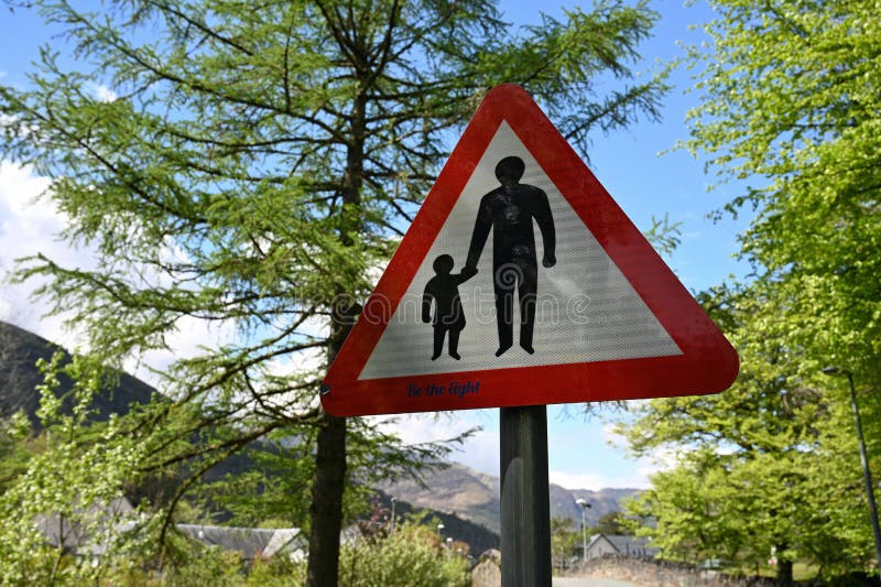 UK traffic sign for pedestrians with person holding hand of child