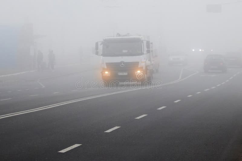 Ukraine, Khmelnitsky, October 2019. Truck traffic on the track in thick fog_ royalty free stock image