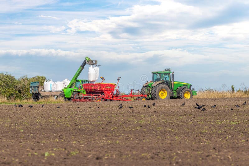 Ukraine, Khmelnytsky region, September 2021. Loading grain into the seeder in the field during the sowing of winter wheat.