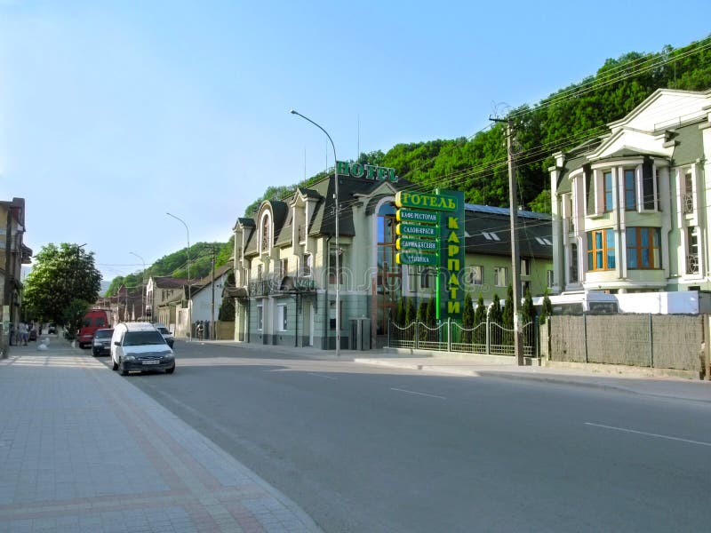 Clean modern street with cottages on the background of mountains in a provincial Ukrainian town