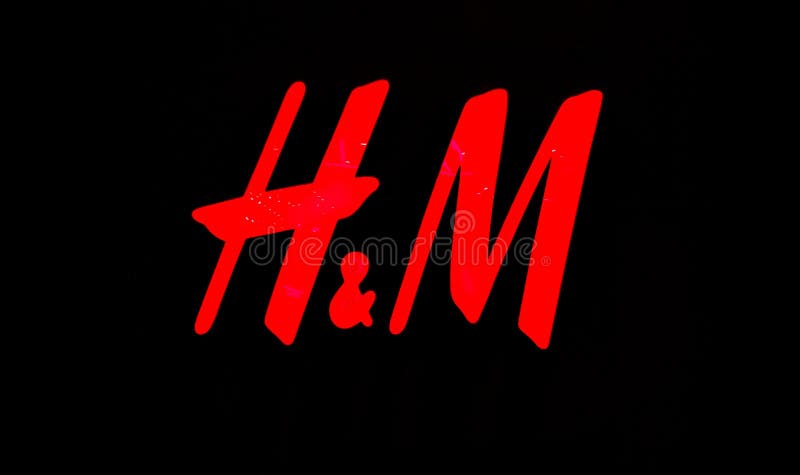 Ukraine, Kiev - September 04, 2019: H M red sign closeup on a black wall. Stylish and fashionable brand clothing with a logo stock photos Ukraine, Kiev - September 04, 2019: H M red sign closeup on a black wall. Stylish and fashionable brand clothing with a logo stock photos