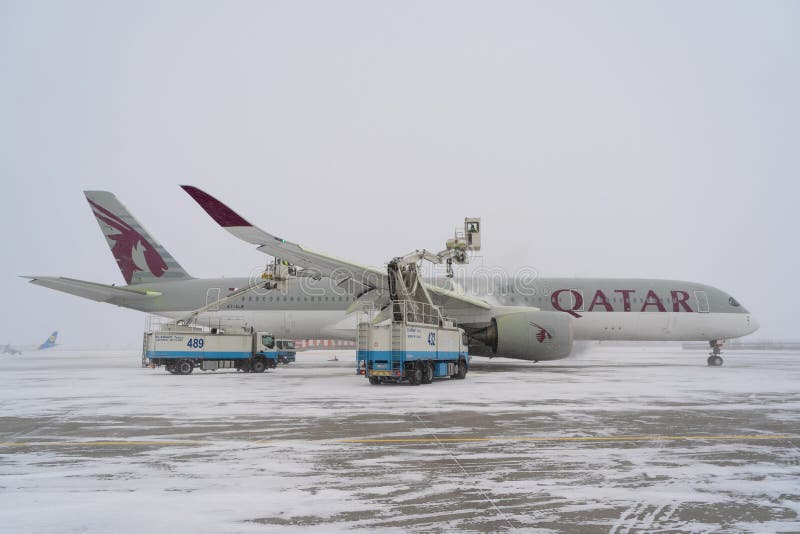 Ukraine, Kyiv - February 12, 2021: De-icing the aircraft before the flight. The deicing machine sprinkles the wing of a