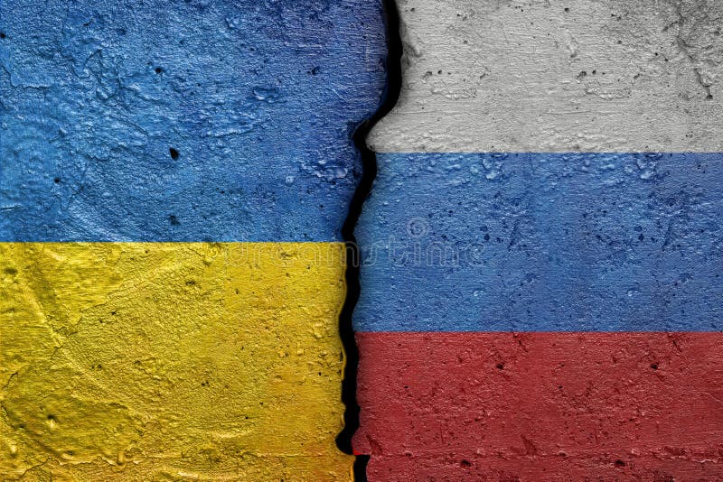 Ukraine and Russia - Cracked concrete wall painted with a Ukrainian flag on the left and a Russian flag on the right stock photo