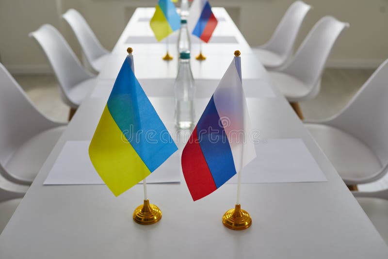 Ukraine and Russia flags on negotiation table before delegates start peace talks considering Ukrainian terms and demands to cease fire, halt aggression, stop war, end conflict and exchange prisoners. Ukraine and Russia flags on negotiation table before delegates start peace talks considering Ukrainian terms and demands to cease fire, halt aggression, stop war, end conflict and exchange prisoners