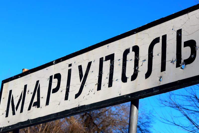 Ukraine Russia war, Road sign in Ukrainian - Mariupol city Donetsk region, pierced by bullets, Ukrainian war in Donbass, Ukraine