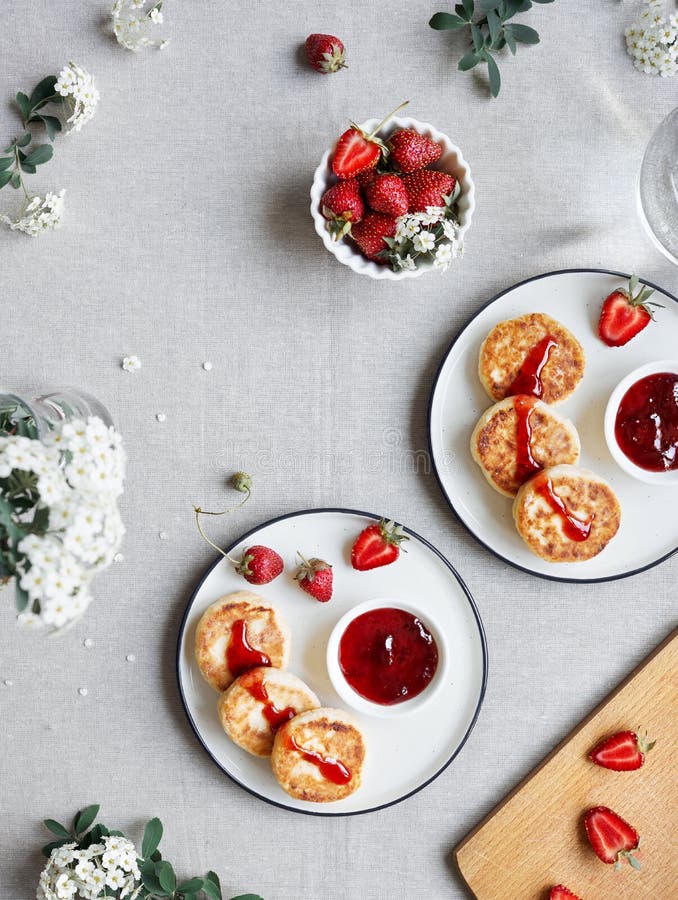 Ukrainian cheese pancakes Syrniki with strawberry jam and berries