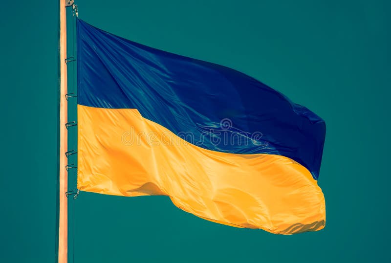 Ukrainian flag against a blue sky. Yellow and blue colors. National symbol of Ukraine. Modern toned photo. stock images Ukrainian flag against a blue sky. Yellow and blue colors. National symbol of Ukraine. Modern toned photo. stock images