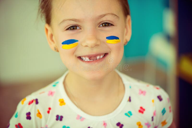 Ukrainian girl with national flag on cheek stock photography